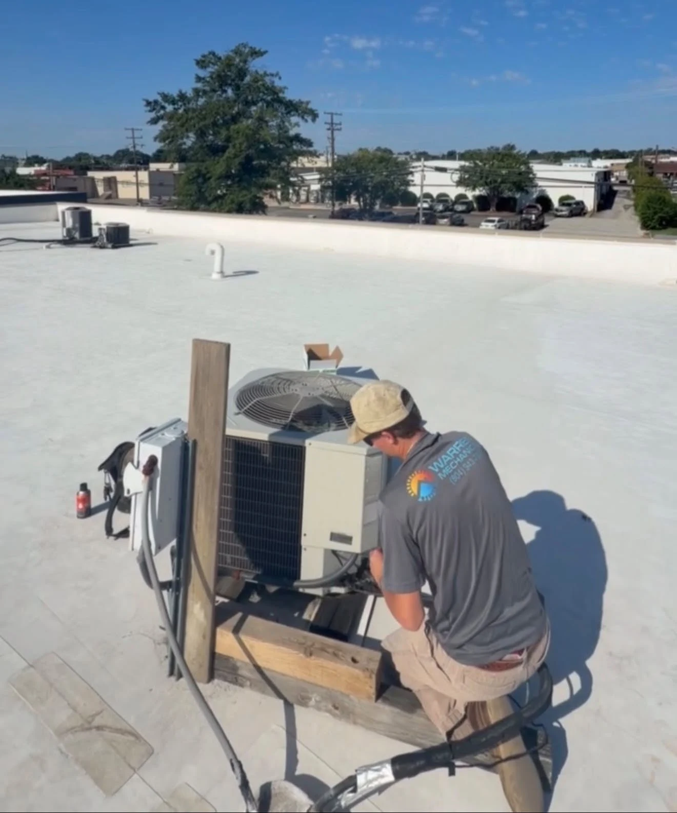 HVAC equipment being serviced at an actual Warren Mechanical rooftop jobsite